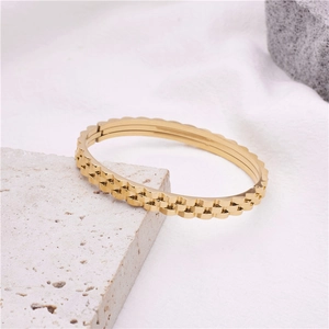 Bracciale rigido dorato in acciaio inossidabile con texture a ingranaggi tipo orologio