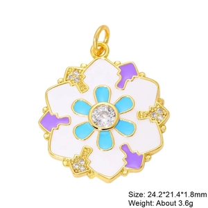 Macro shot of colorful floral enamel pendant with zircon center and gold plating