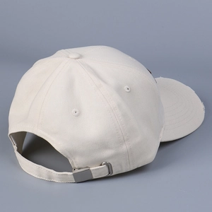 Detail of adjustable metal buckle and stitching on beige cotton baseball cap