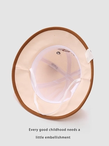 Internal detail of beige toddler sun hat with brown trim and adjustable windproof strap