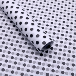 Detail view of semi-transparent black and white polka dot silk tissue paper texture