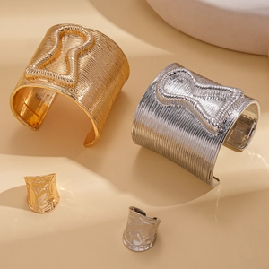 Textured metallic bangle and ring set with hourglass linear patterns in gold and silver