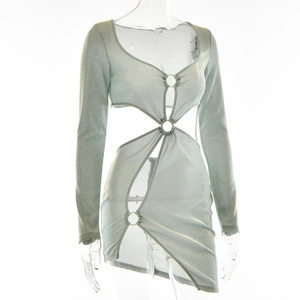 Dettaglio dell'abito corto verde chiaro con cut-out che mostra l'anello sul petto