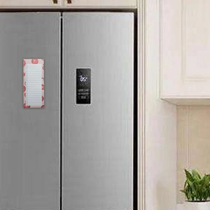 Magnetic pink memo pad with apple design attached to a silver refrigerator surface