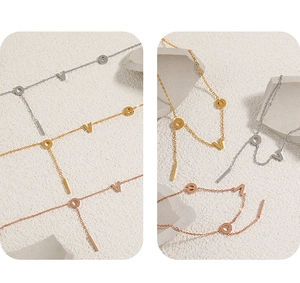 Detailed macro view of LOVE letter charms on gold, silver, and rose gold anklets