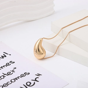 Fashion gold hollow teardrop pendant necklace with a sleek snake chain on white background
