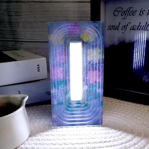 Detail of a trapezoidal resin night light with dried flowers and embedded LED lights