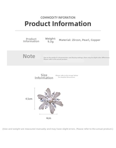 Macro shot of a floral brooch featuring cubic zirconia petals and a center pearl detail