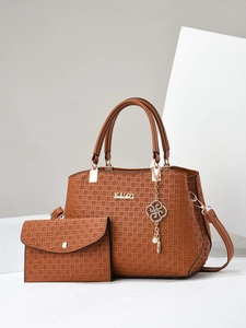 Brown textured woven tote bag with clover charm and matching small clutch set