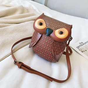 Detailed close-up of owl-shaped crossbody bag with feather prints and adjust shoulder strap