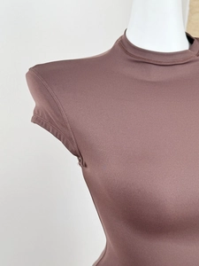 Detail shot of the mock neck and shoulder stitching on a brown slim fit athletic t-shirt