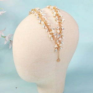 Detail of handmade crystal pearl bridal headband with golden wire and rhinestones
