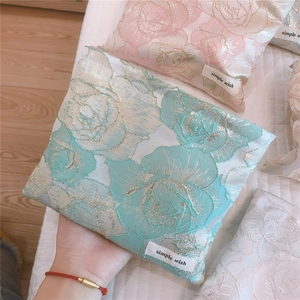 Close-up of elegant rose jacquard makeup bags with simple wish labels in various colors