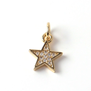 Macro shot of gold-plated star pendant with cubic zirconia inlay and top ring