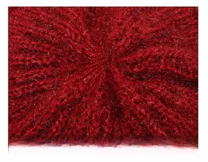 Macro shot of red knit beanie showing detailed stitching and silver metallic yarn weaving