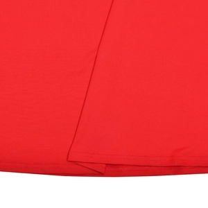 Macro detail of red ruched mesh dress showing precise stitching and knit fabric texture
