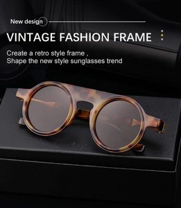 Detail of retro round tortoiseshell sunglasses on a black leather case with metal accents