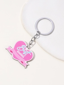 Close-up of pink heart keychain with Best Mom text and silver ring on neutral base