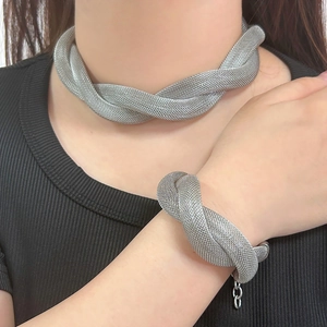 Silver double-layer twisted mesh necklace and bracelet set worn by a model