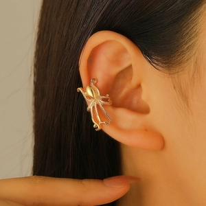 Polished gold octopus ear cuff featuring detailed tentacles for non-pierced ears