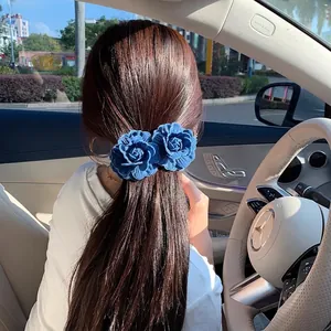 Vintage denim blue rose hair clips for women shown in a stylish ponytail hairstyle