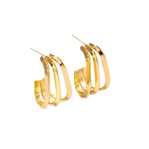 Detailed macro view of gold-plated square twisted hoop earrings with layered metal lines
