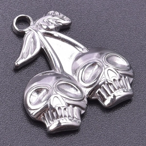 Detailed view of skull cherry pendant in silver stainless steel with realistic carving