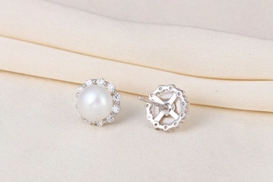 Detailed macro view of S925 silver stud earring with white pearl and zircon halo