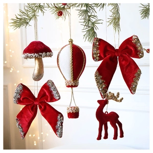 Detail of red velvet Christmas ornaments with sequins hanging on a tree branch