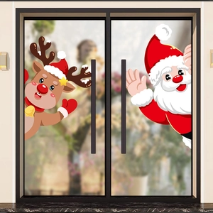 Christmas window stickers featuring Santa and Reindeer designs on a glass door background