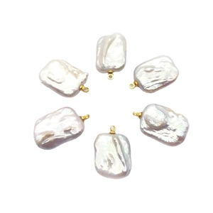 Baroque natural freshwater pearl pendants with gold loops arranged in a circular pattern