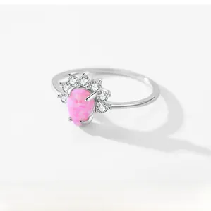 Detail of pear-cut pink opal ring with halo diamonds and polished S925 silver band