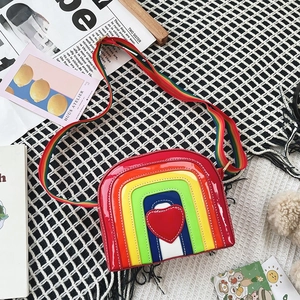 Detailed macro of rainbow heart crossbody bag with glossy texture and wide colorful strap