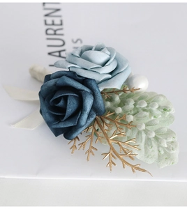 Detail of blue artificial roses groom boutonniere with golden leaves and pearls