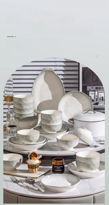 Detail of green ceramic dinnerware set with wavy textures and gradient glaze finish