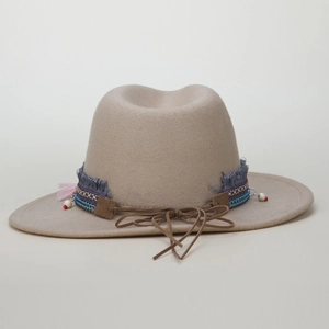 Detail of wide brim wool fedora with ethnic woven band, tassels and beaded accents