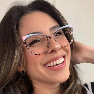 Close-up of model wearing cat-eye frames with pink blue and tortoiseshell finish