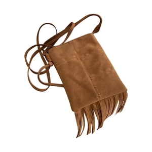 Bohemian brown suede crossbody bag with long tassels and cross-stitch detail on white background