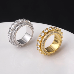 Close-up of hip hop spinner ring with five rows of pavé zircons in gold and silver
