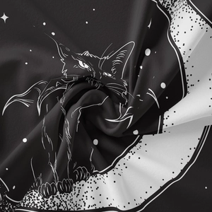 Close-up of feline with bat wings on a crescent moon fabric tapestry texture