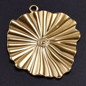Macro shot of 304 stainless steel gold flower pendant with radial texture and ring