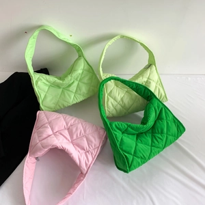 Detailed view of quilted nylon shoulder bags in neon green, pale yellow, pink and grass green