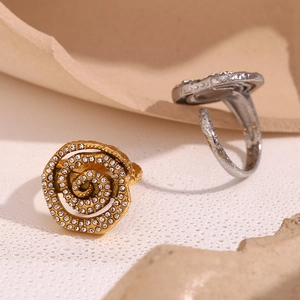 Detail of gold-plated vortex ring featuring shimmering pave-set crystals on metal
