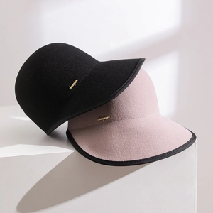 Designer vintage wool felt cloche hats in black and dusty pink with gold metal logo