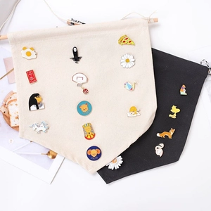 Detail of beige and black canvas banners for displaying enamel pins and badges