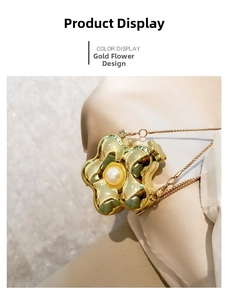 Detailed macro view of a golden flower mini bag featuring a pearl center and fine chain