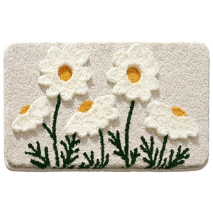 Thick absorbent floral bath mat with plush white daisies and green leaves on cream base
