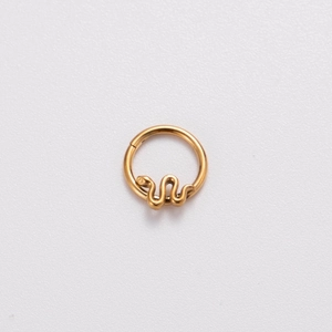 Detail of golden stainless steel hinged hoop ring with small snake pendant charm