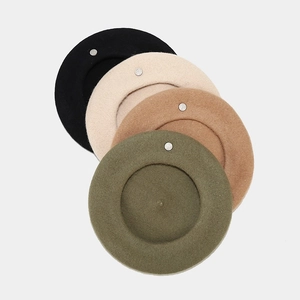 Detail of wool beret set in black beige camel and green with silver metal logo