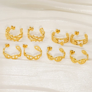 Detail of four pairs of gold-plated stainless steel earrings with star and moon motifs